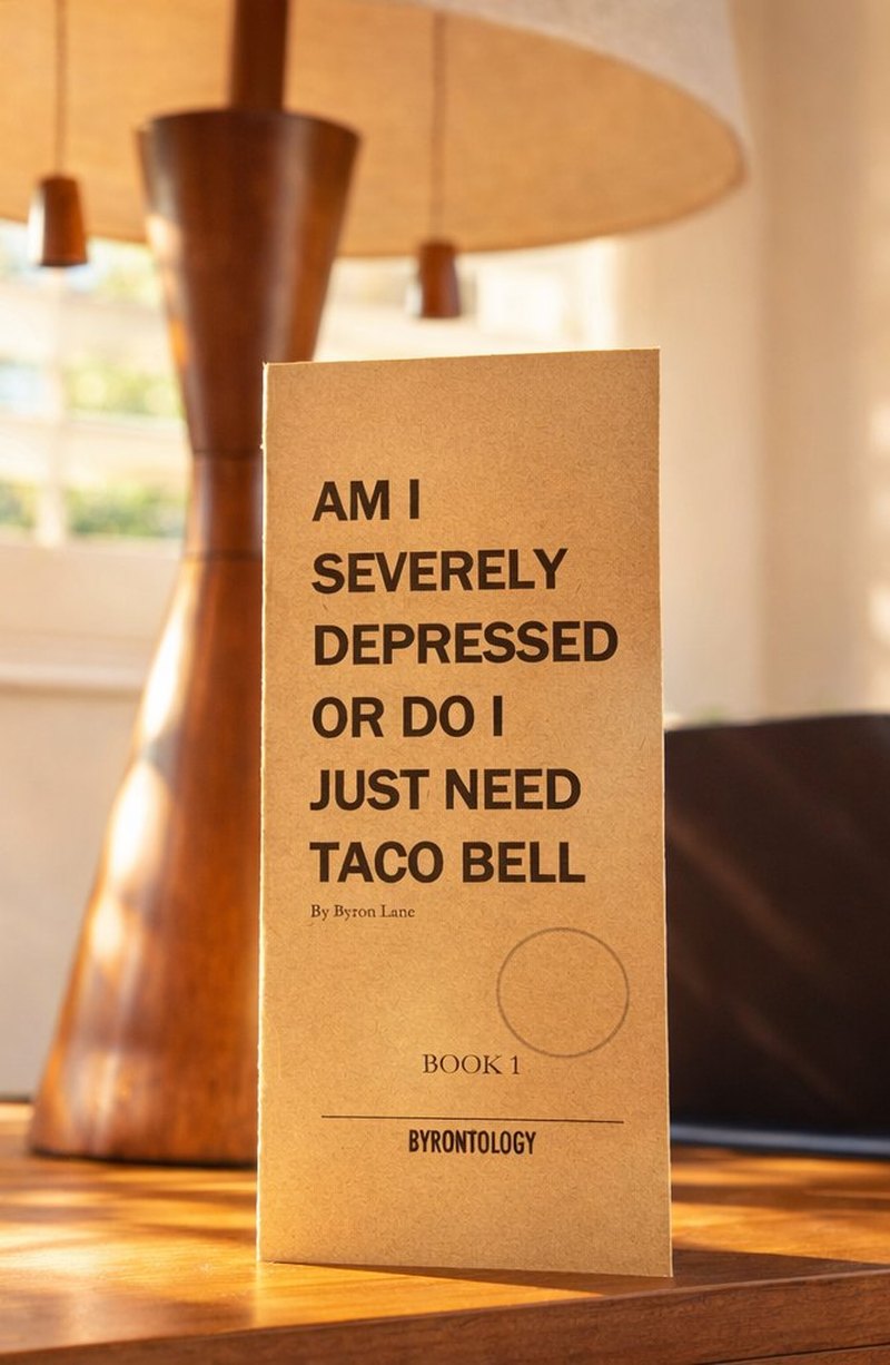 Byronbook 1: Am I Severely Depressed or Do I Just Need Taco Bell, a handmade booklet on a desk.